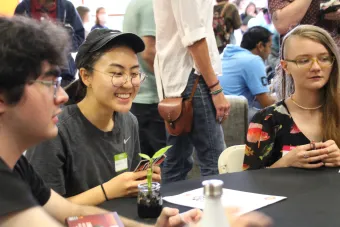 Student smiling with other students around them