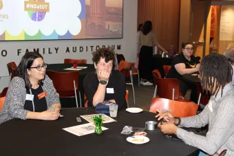 Staff sitting at a table talking