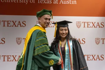Dr. Robert Valdez shakes hands with a student at First-Gen Grad.