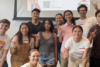 Students posing for a photo with the Horns Up sign.