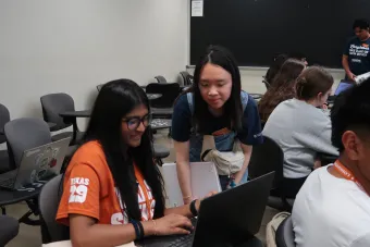 An orientation advisor offers course registration assistance to a student at Longhorn Orientation