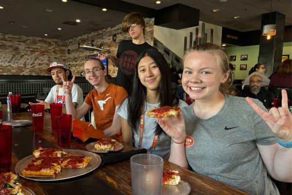 Students enjoying pizza at VIA 313 during TEXPO