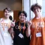 students posing together with a hookem horns