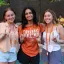 students posing together with a hookem horns