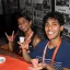 students posing together with a hookem horns