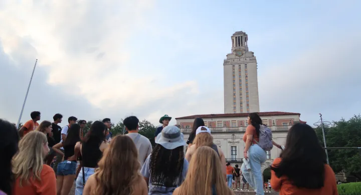 students walking up stairs with the UT Tower in the background