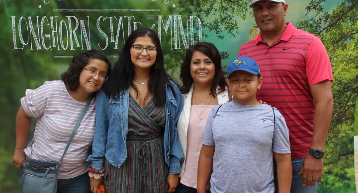 student with parents at orientation at UT Austin