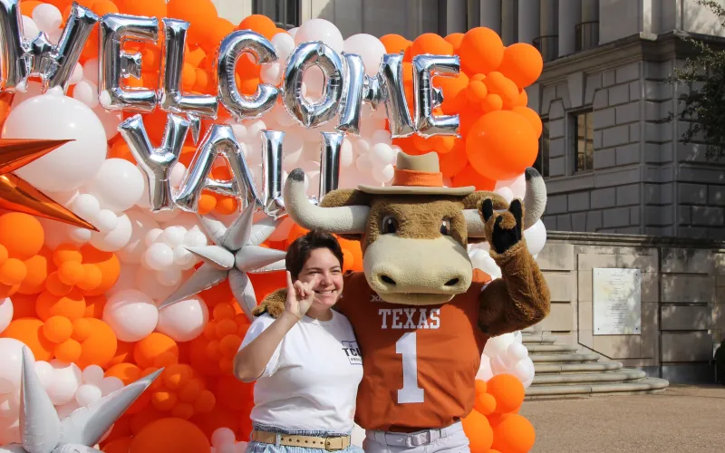 Student poses with Hook 'Em at Welcome Bash 2023.